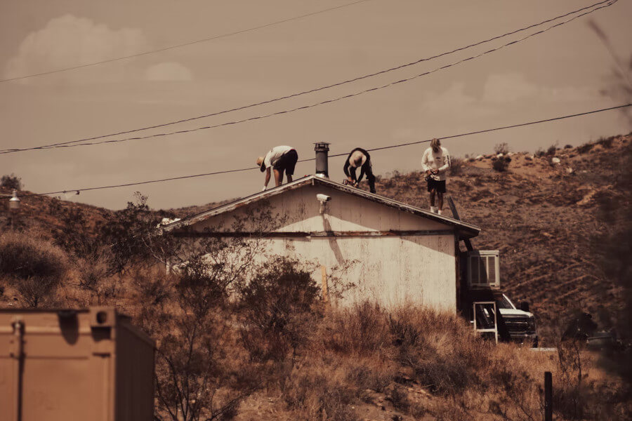 3 people working on a roof. Image by Unsplash