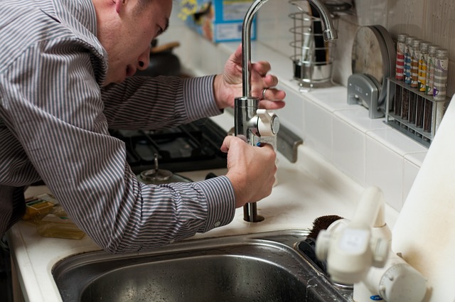 plumber fixing a faucet