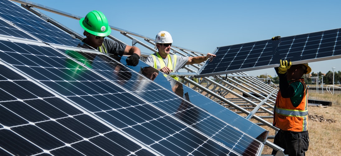 3 people installing solar panels