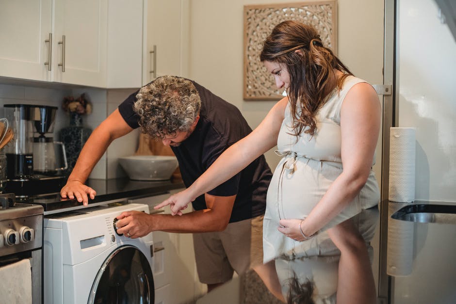 Pregnant women pointing at a washer