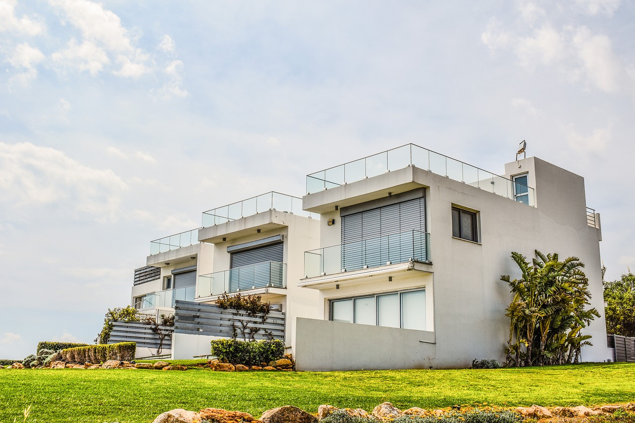 Large white townhouse with balconies