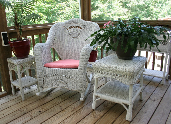 Wicker furniture on a porch, plants