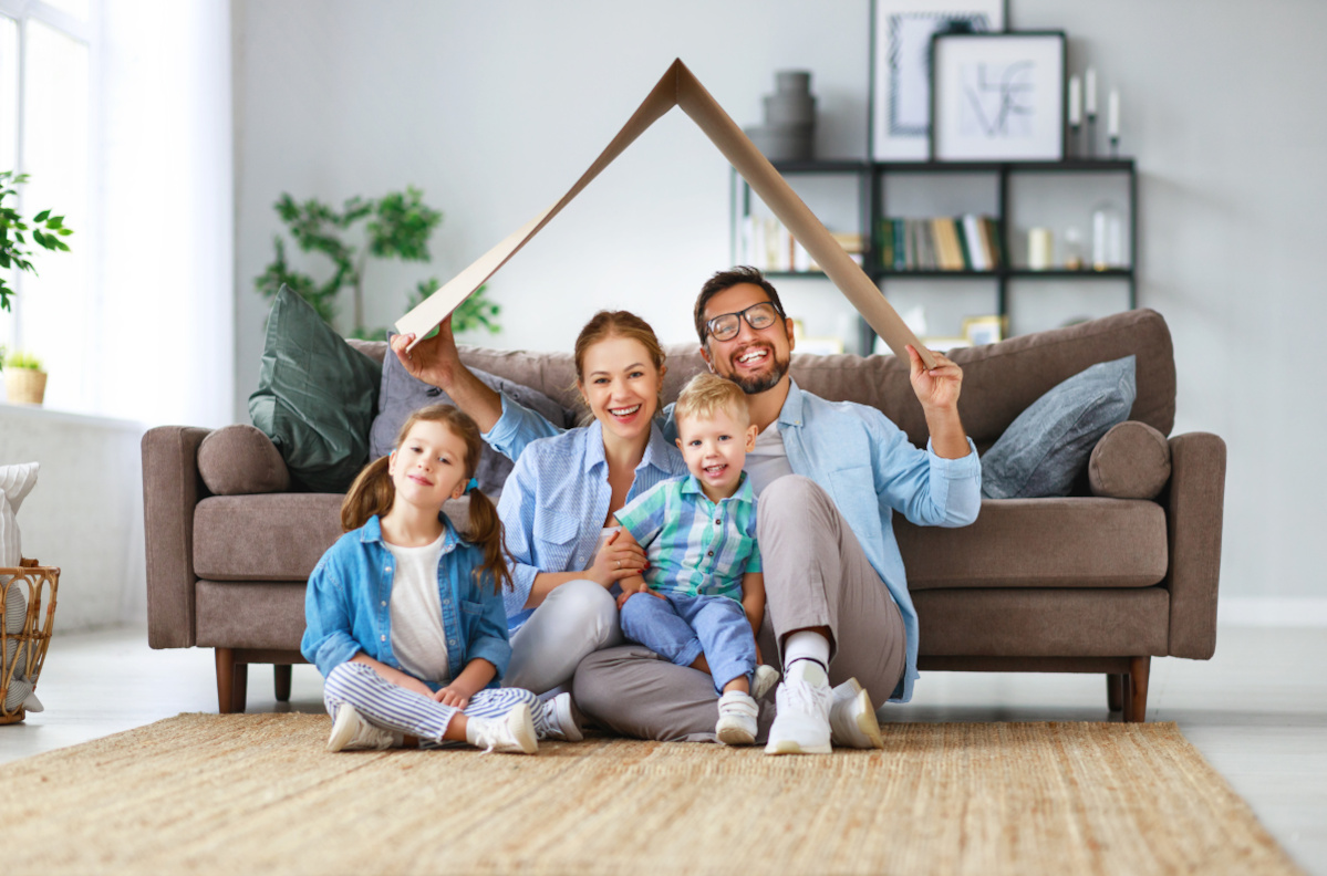 family sitting on the floor in front of a sofa