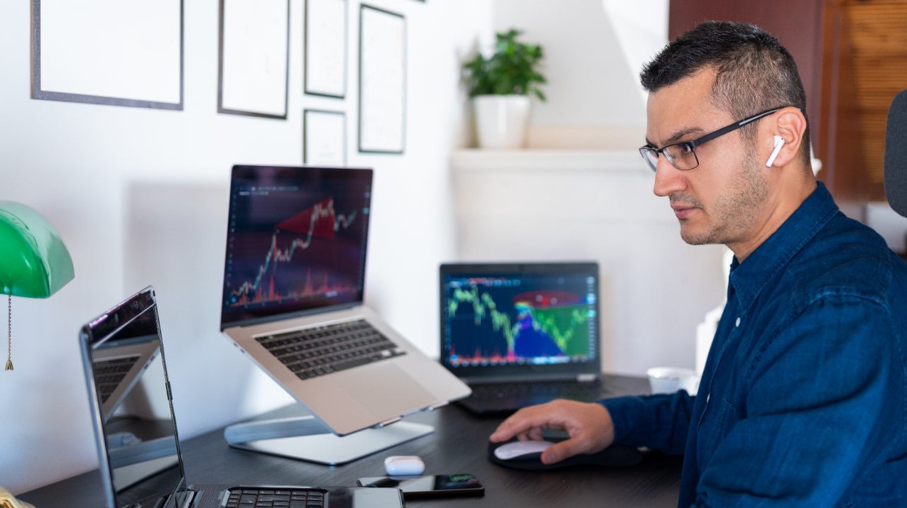 person in front of multiple computers