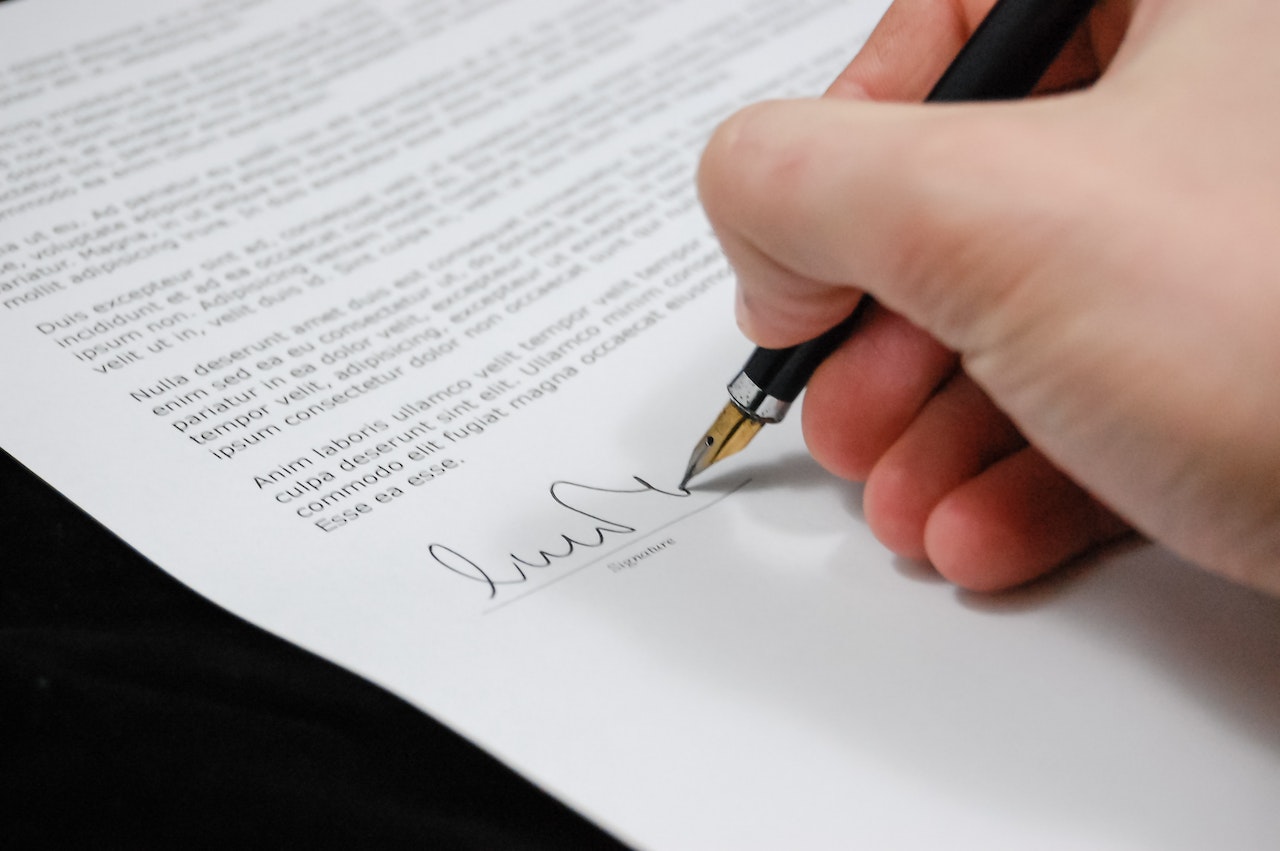 Person signing a paper