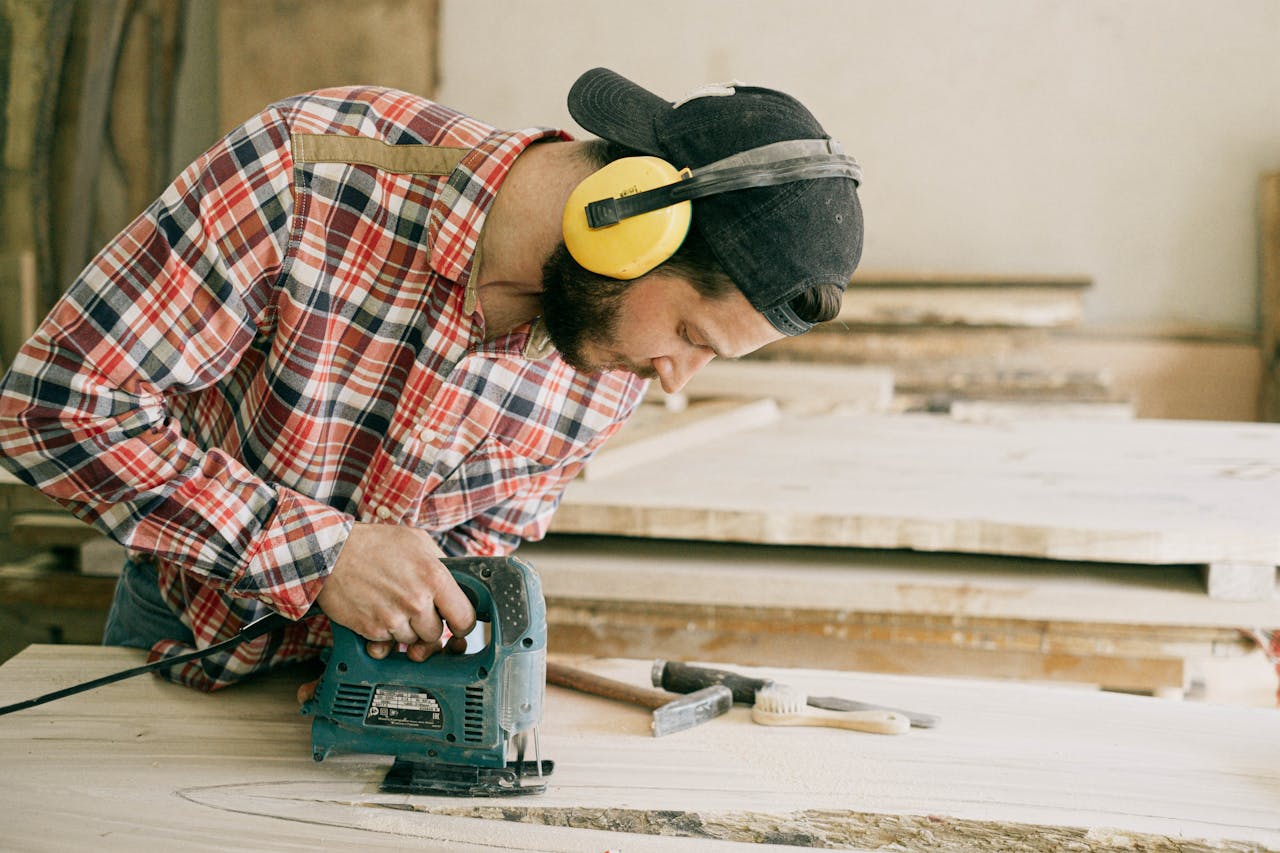 Person using a saw. Image by Pexels