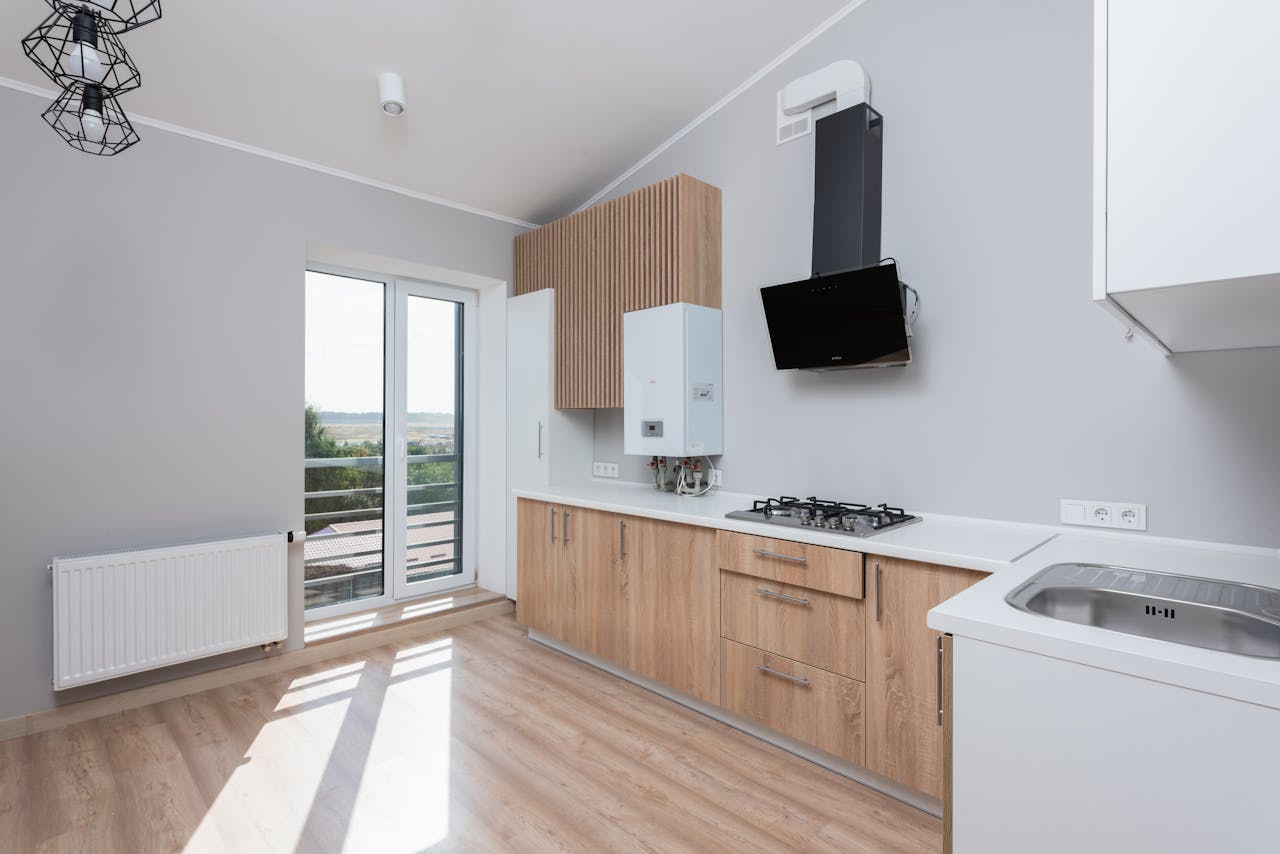 Brown kitchen cabinets with a white countertop. Image by Pexels