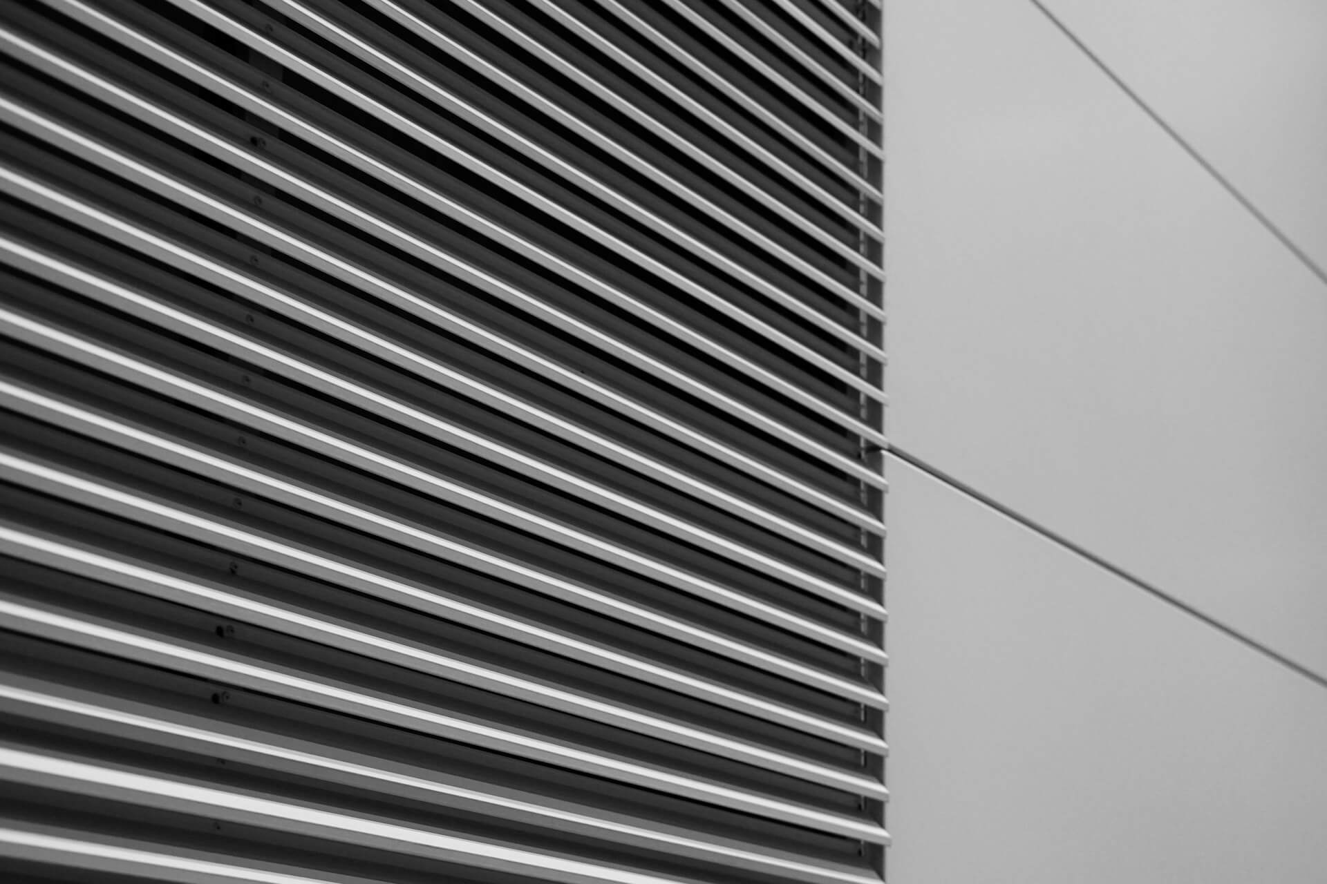 Black and white photo of the side of a building. Image by Unsplash