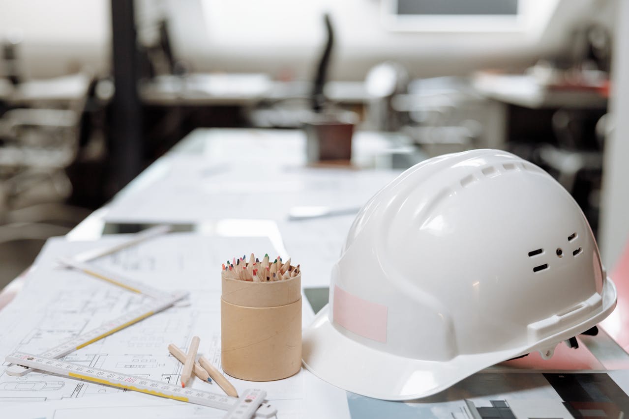 White hard hat next to a kraft paper jar. Image by Pexels