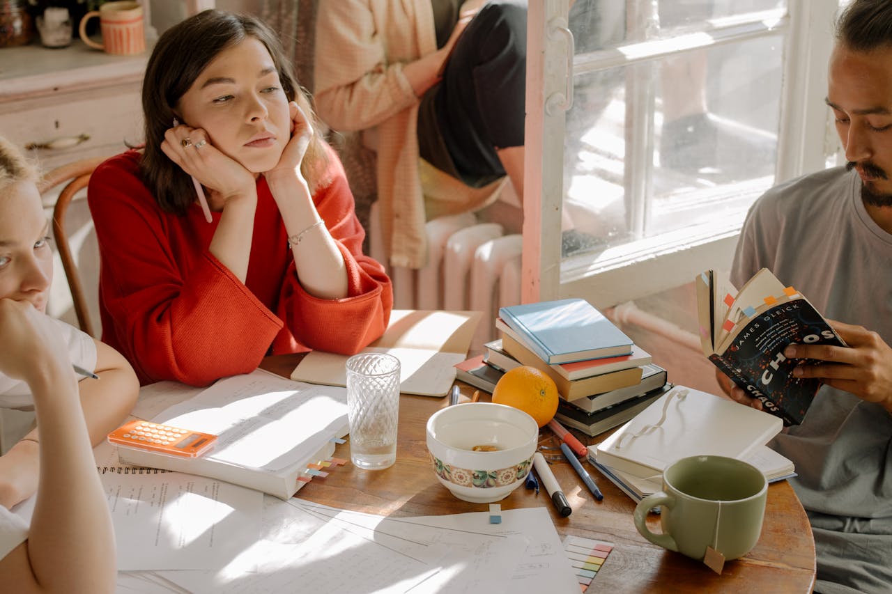 3 people studying at a table. Image by Pexels