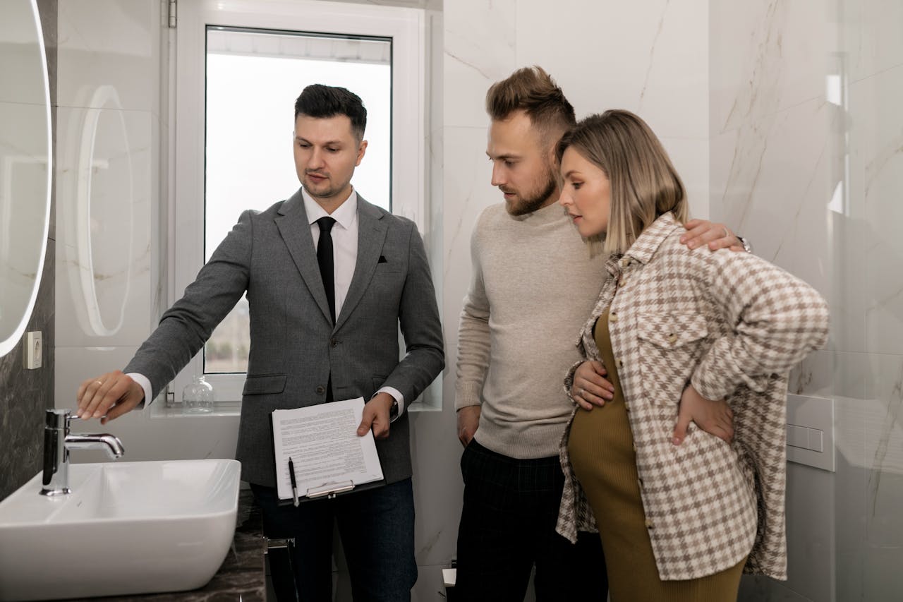 Real estate agent showing the bathroom of a house. Image by Pexels