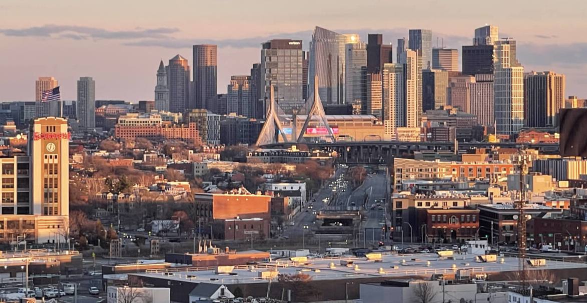 Downtown Boston skyline and the Zakim Bridge at sunset, photographed from Assembly Square in Somerville