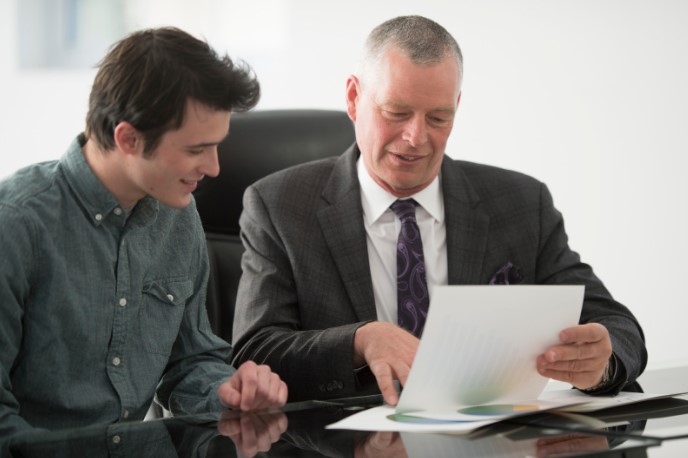 2 people looking at paperwork