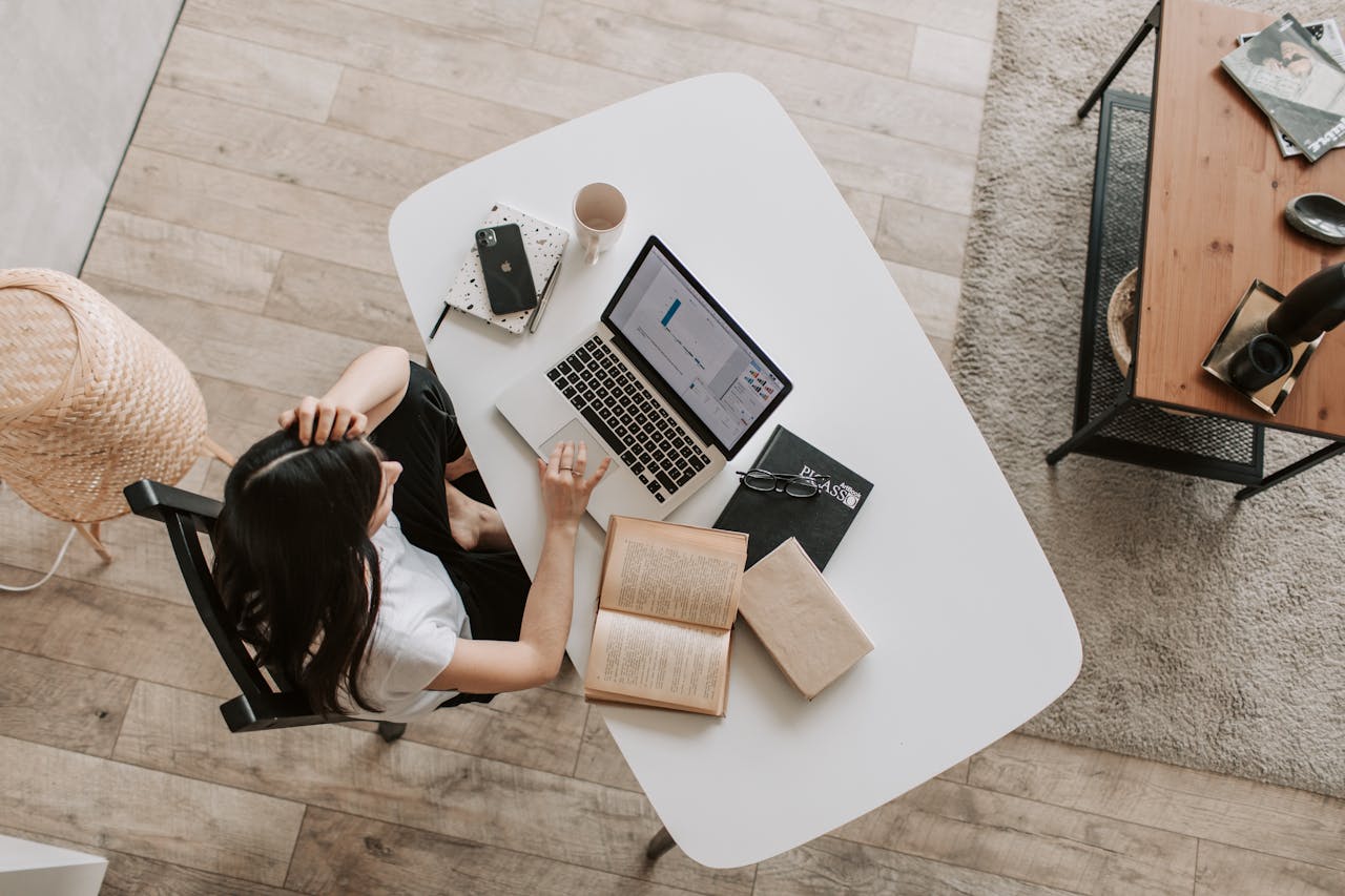 arial view of a person using a laptop. Image by Pexels