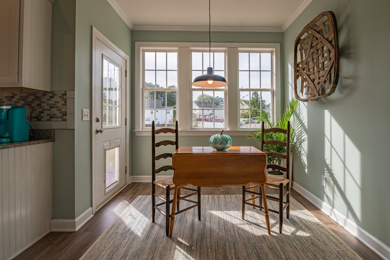 Kitchen with a small brown kitchen table and two chairs. Image by Pexels