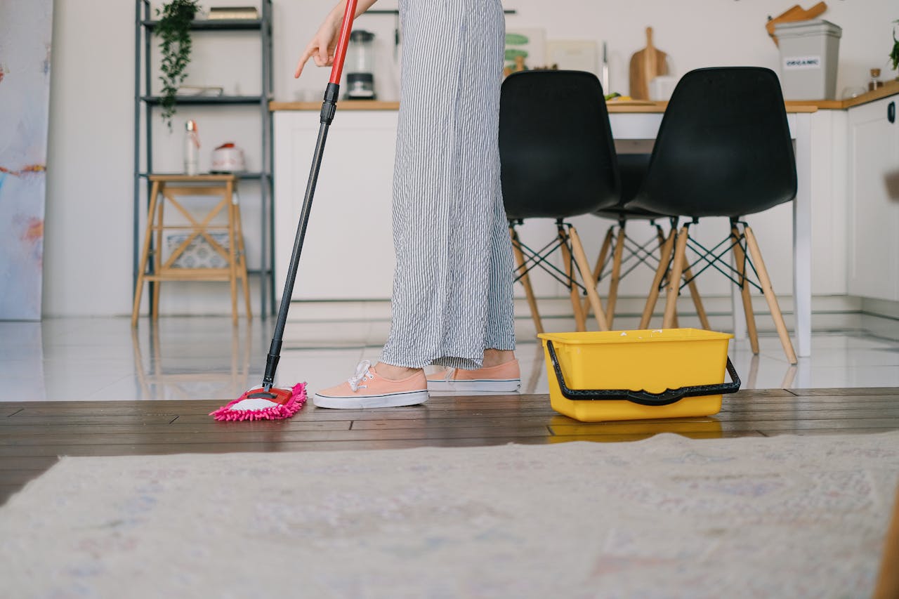 Person cleaning the floor. Image by Pexels