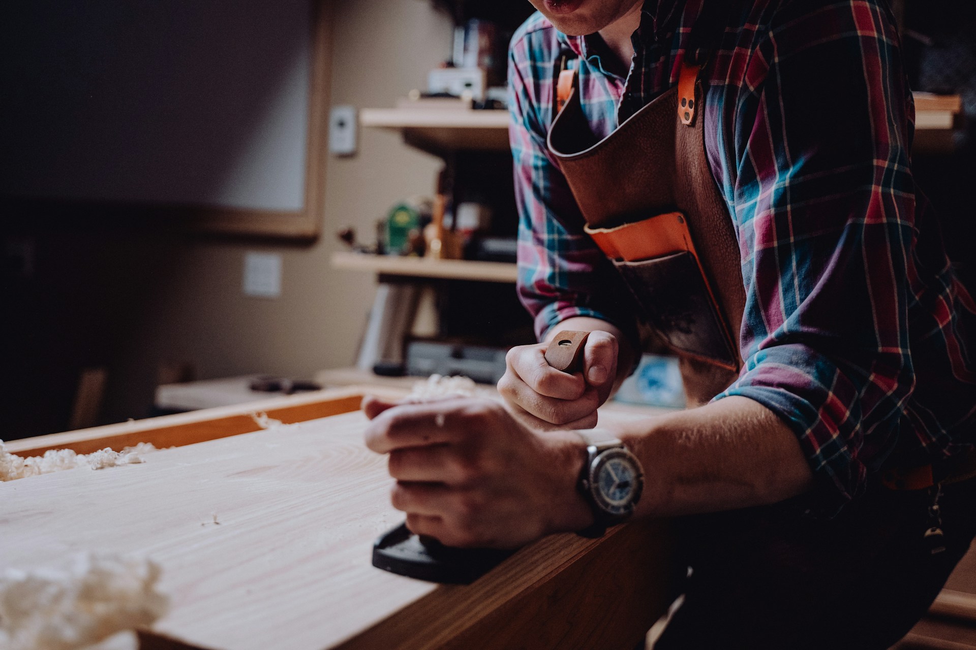 Person working on a piece of wood. Image by Unsplsh