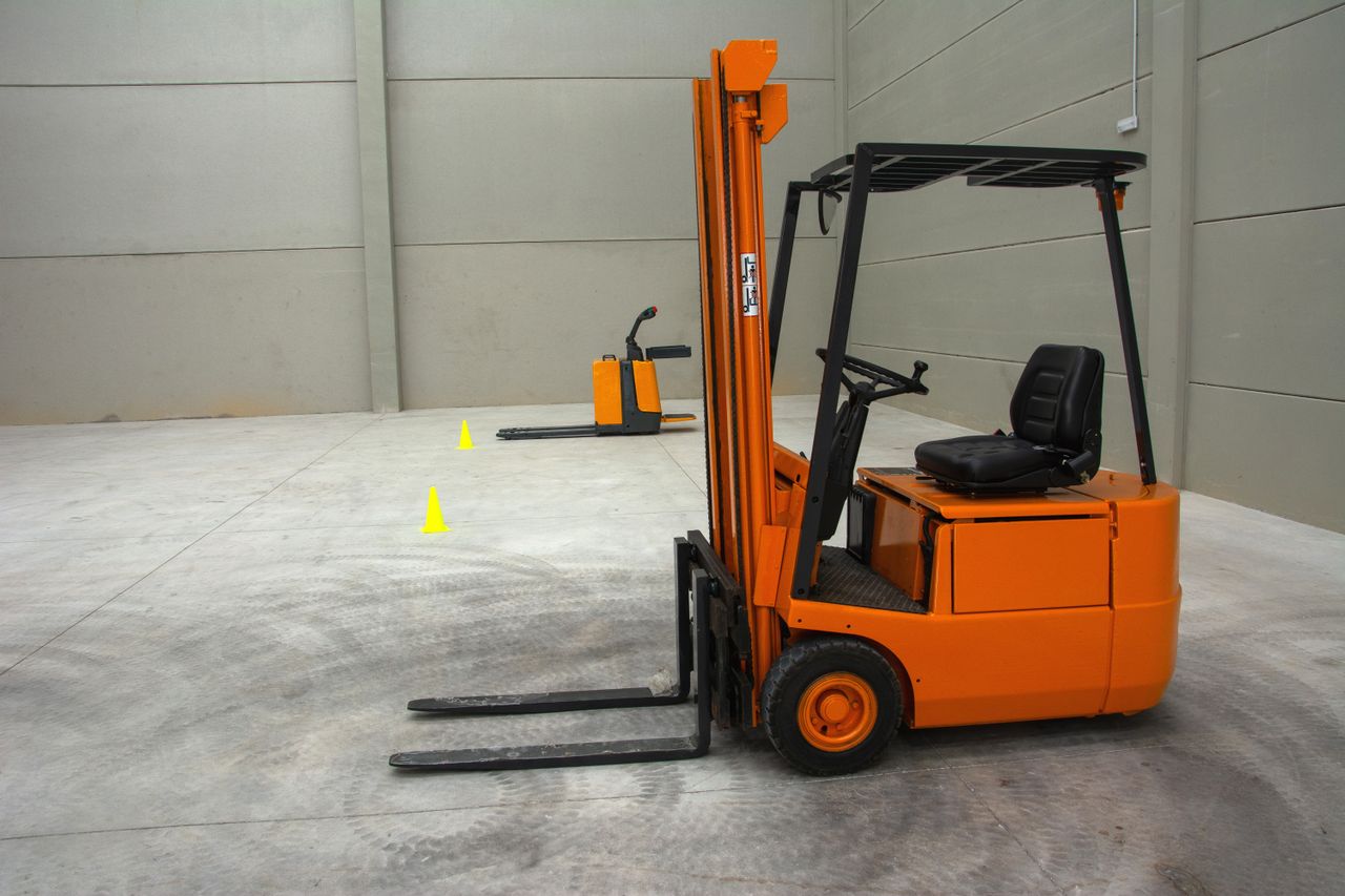 Orange and black forklift operating on an outdoor industrial worksite representing the diesel and LPG forklift selection decision for Brisbane operators. Photo by Ani Set on Pexels