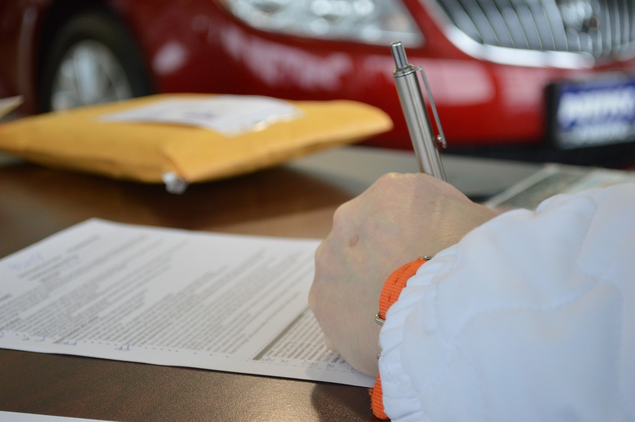 Person signing a contract. Image by Pixabay