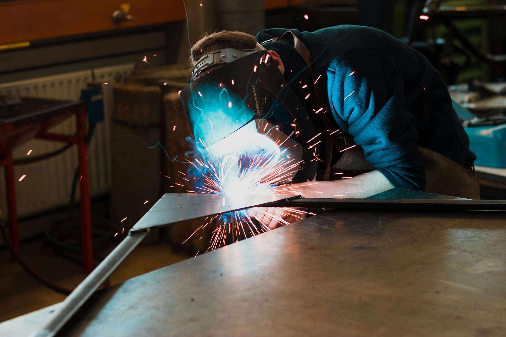 Performing Metal Welding in Industrial Environment. Image by Unsplash