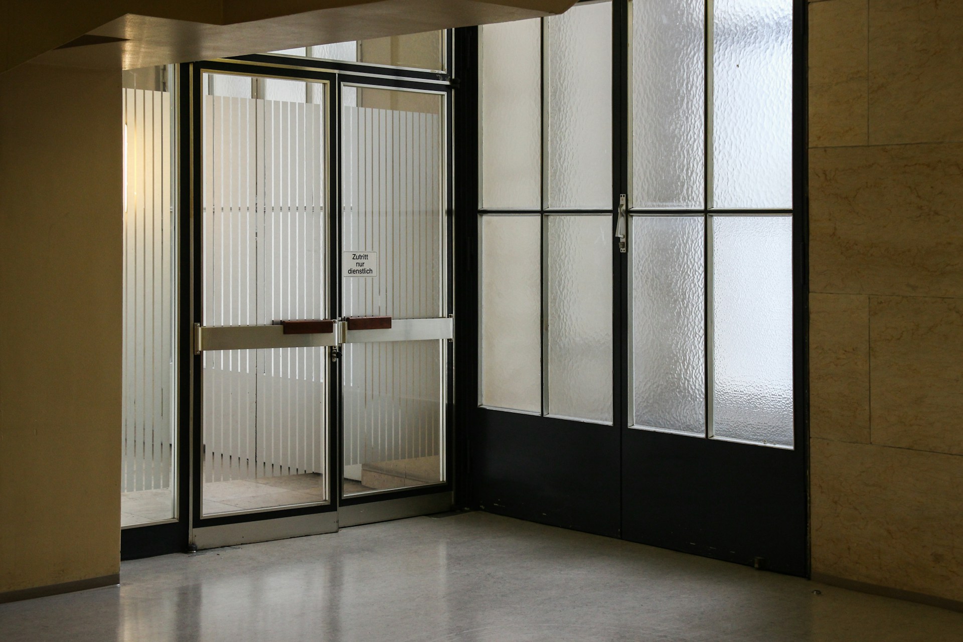 Closed gray stainless steel framaed glass door. Image by Unsplash