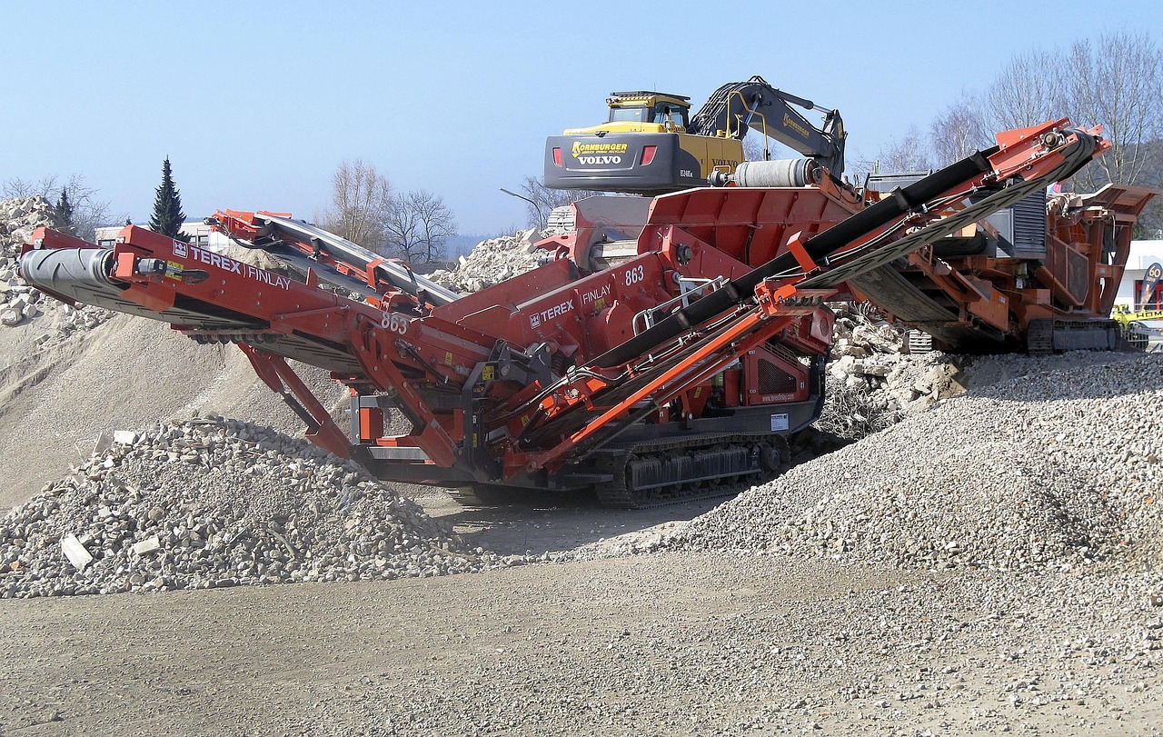 A rubble crusher and excavator at a demolition site