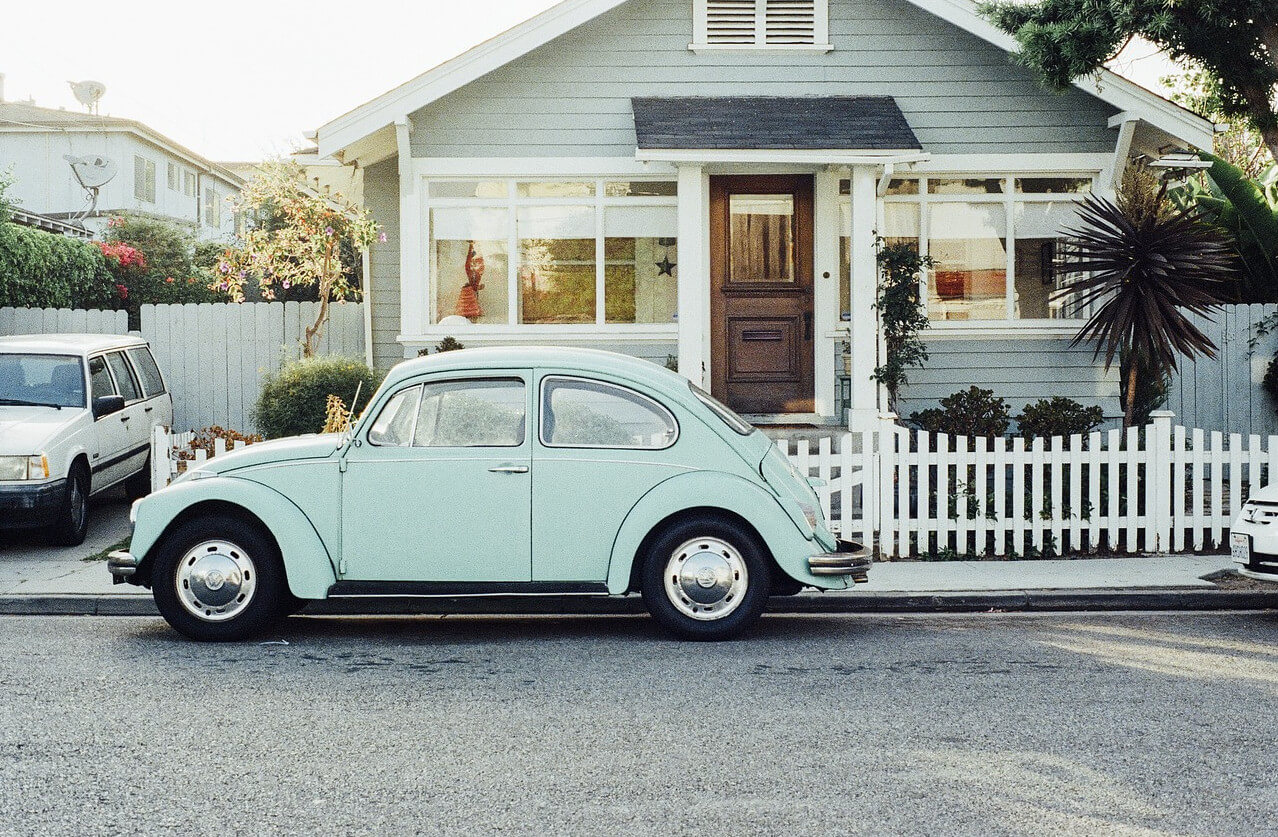 Classic vehicle parked in front of a property showcasing outdoor improvements and curb appeal. Image via Pixabay