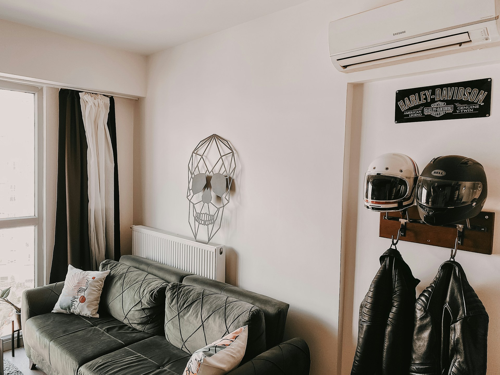Small room with desk, bed and wardbrobe. Blue walls, green and white curtains. Image by Pexels