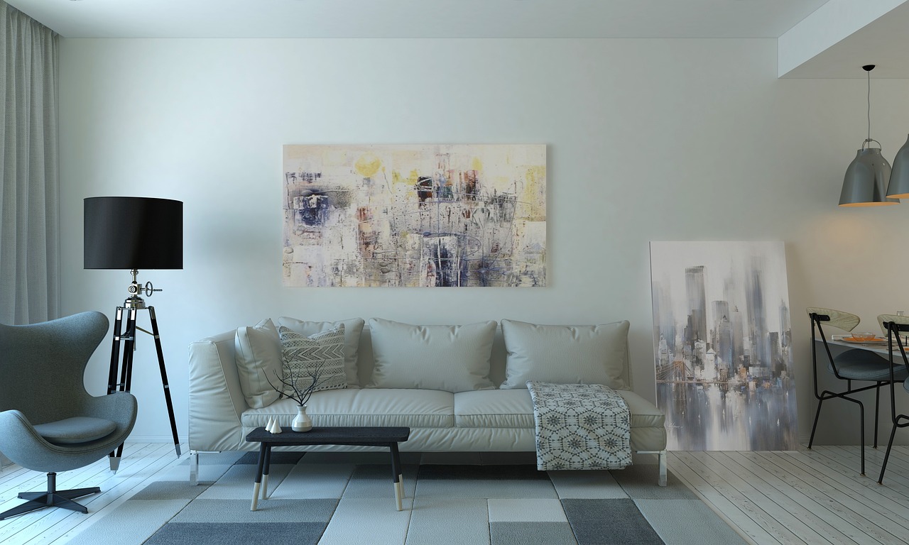 Livingroom, with art on wall and one leaning agains a wall. Image by Pixabay