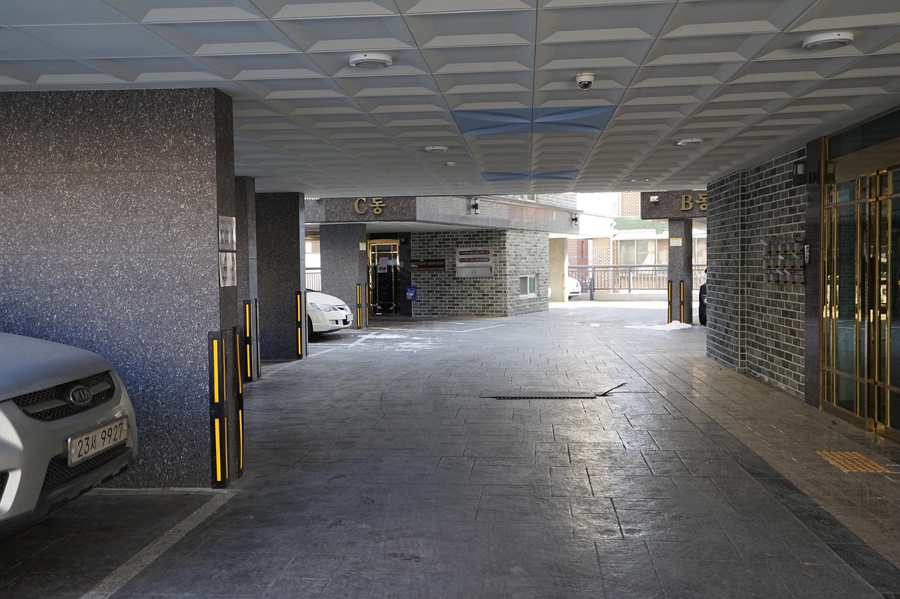 Cars parked in an underground parking garage of a condominium building. Image via Pexels