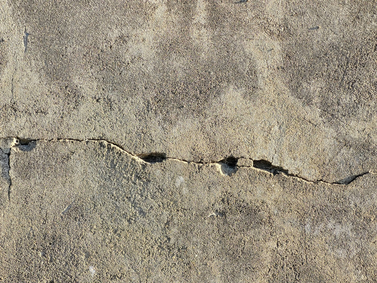 Crack in a concrete wall. Image by Unsplash