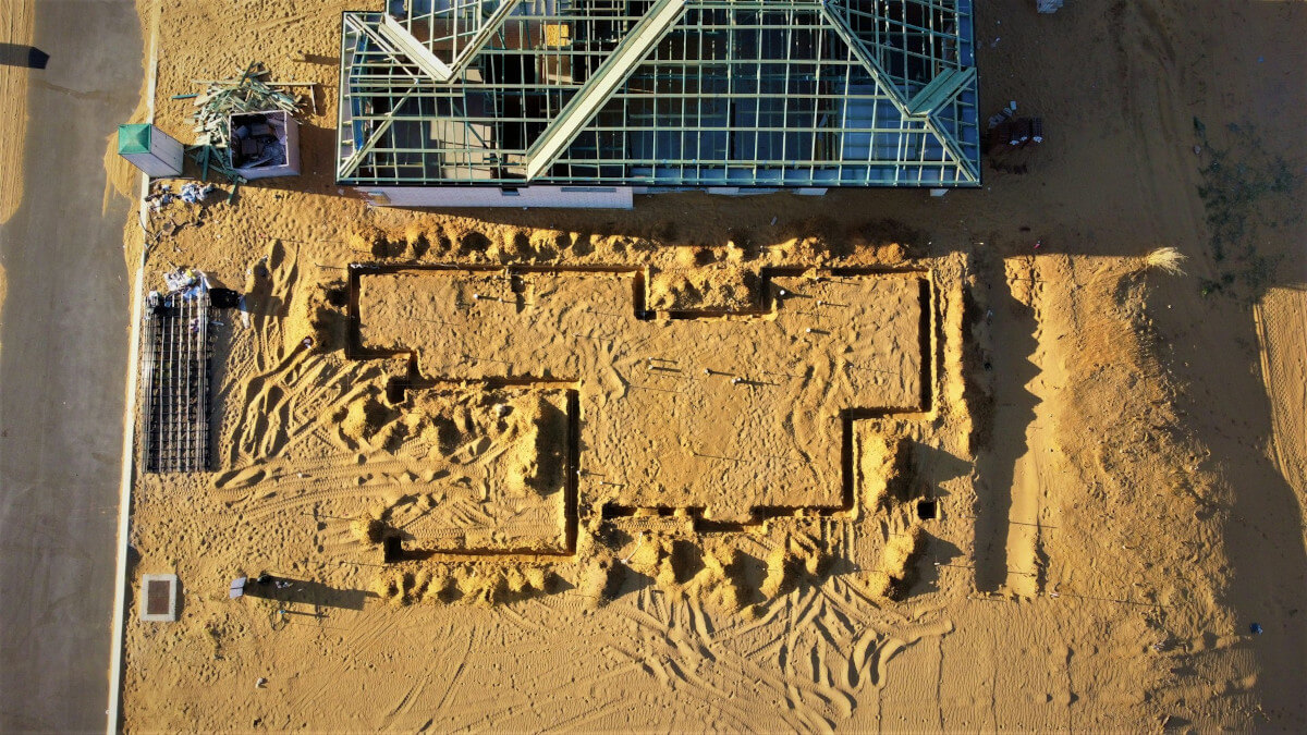 Arial view of a building in the sand. Image by Unsplash.