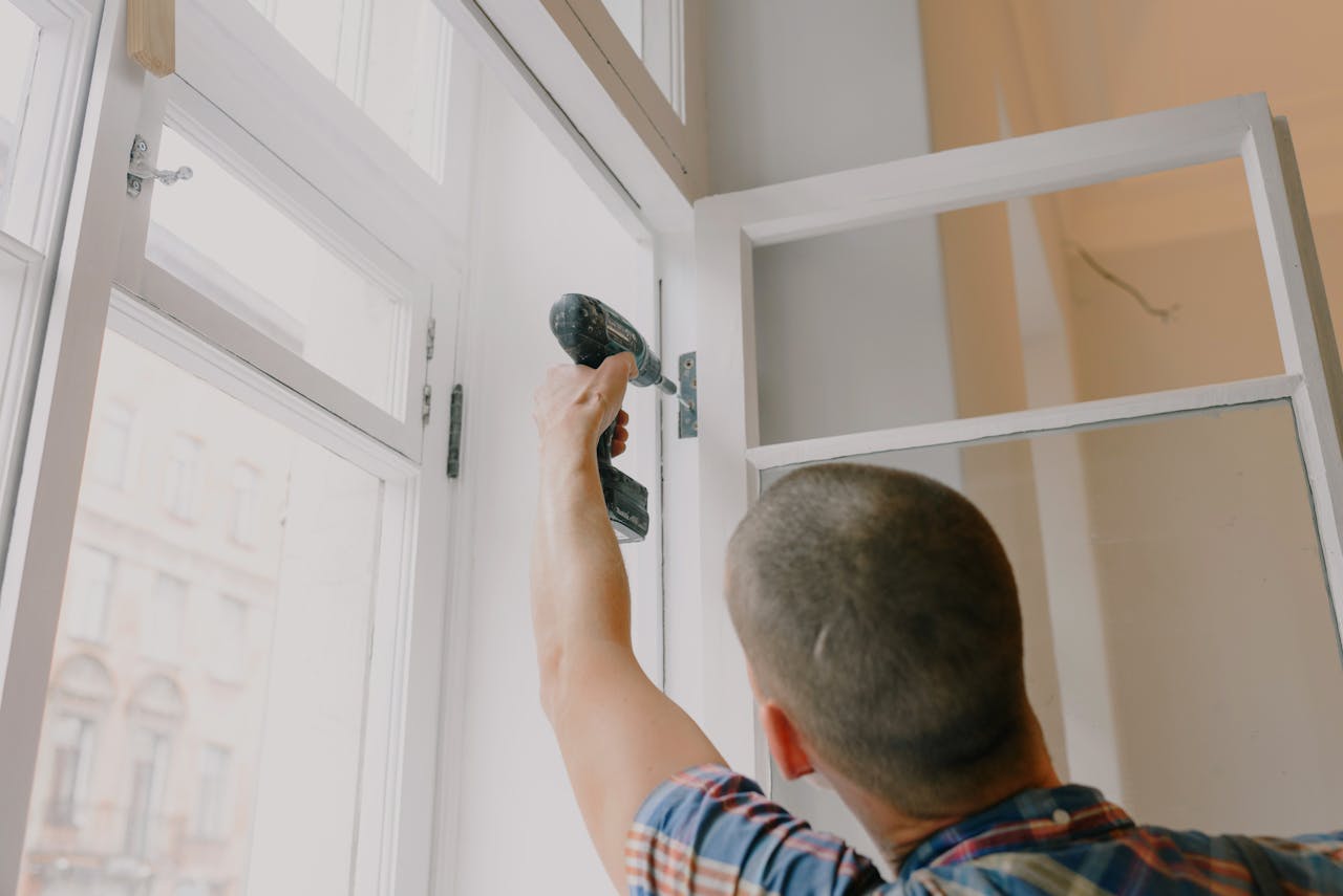 Person installing a window. Image by Pexels