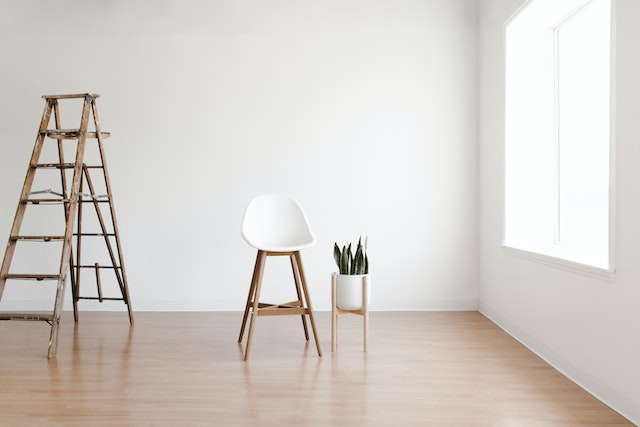white walls, ladder and a chair