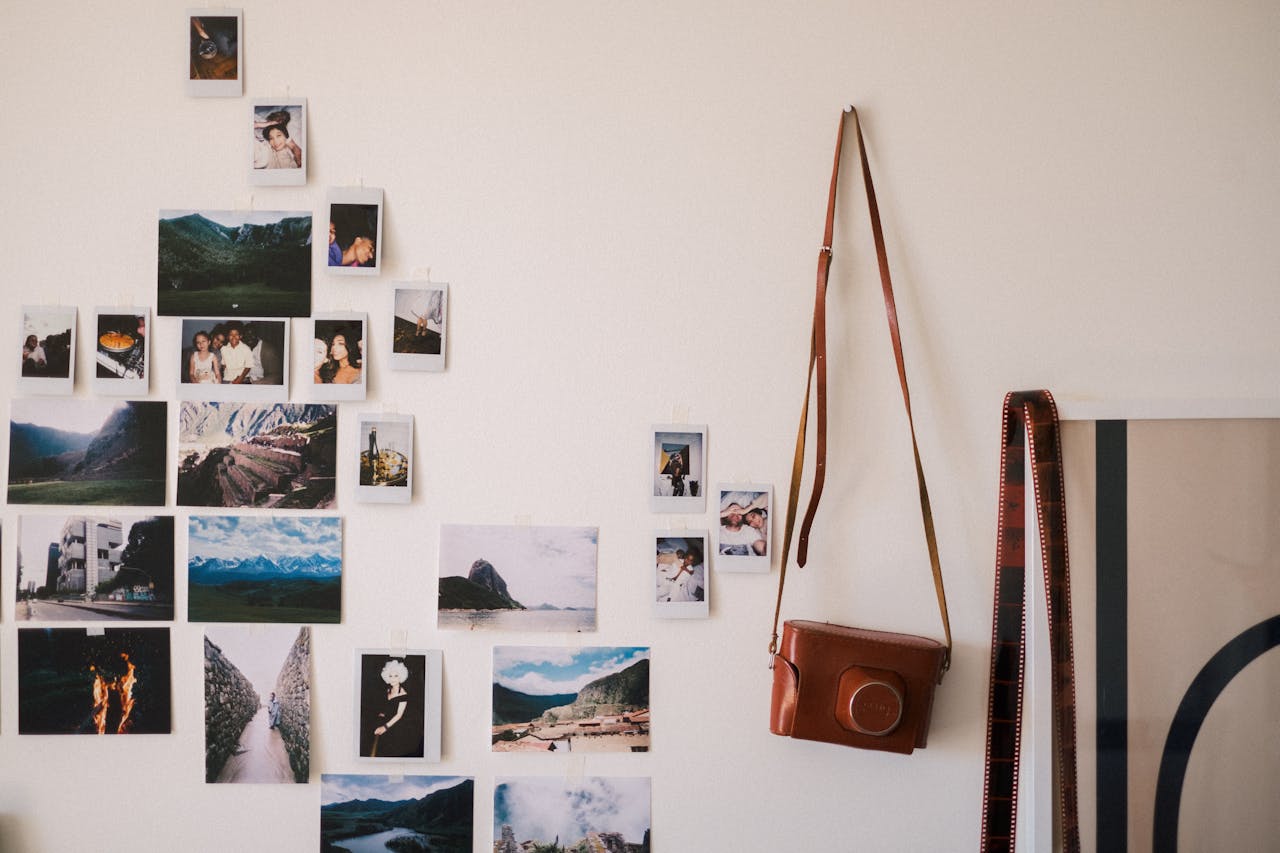 Pictures and a camera hanging off the wall. Image by Pexels