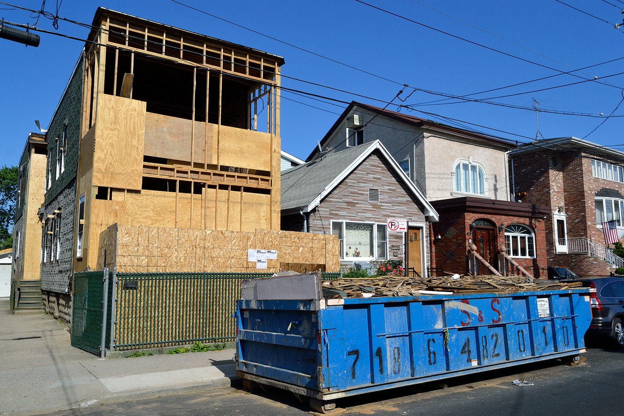 Blue container filled with wood. New house construction. Image by Pixabay