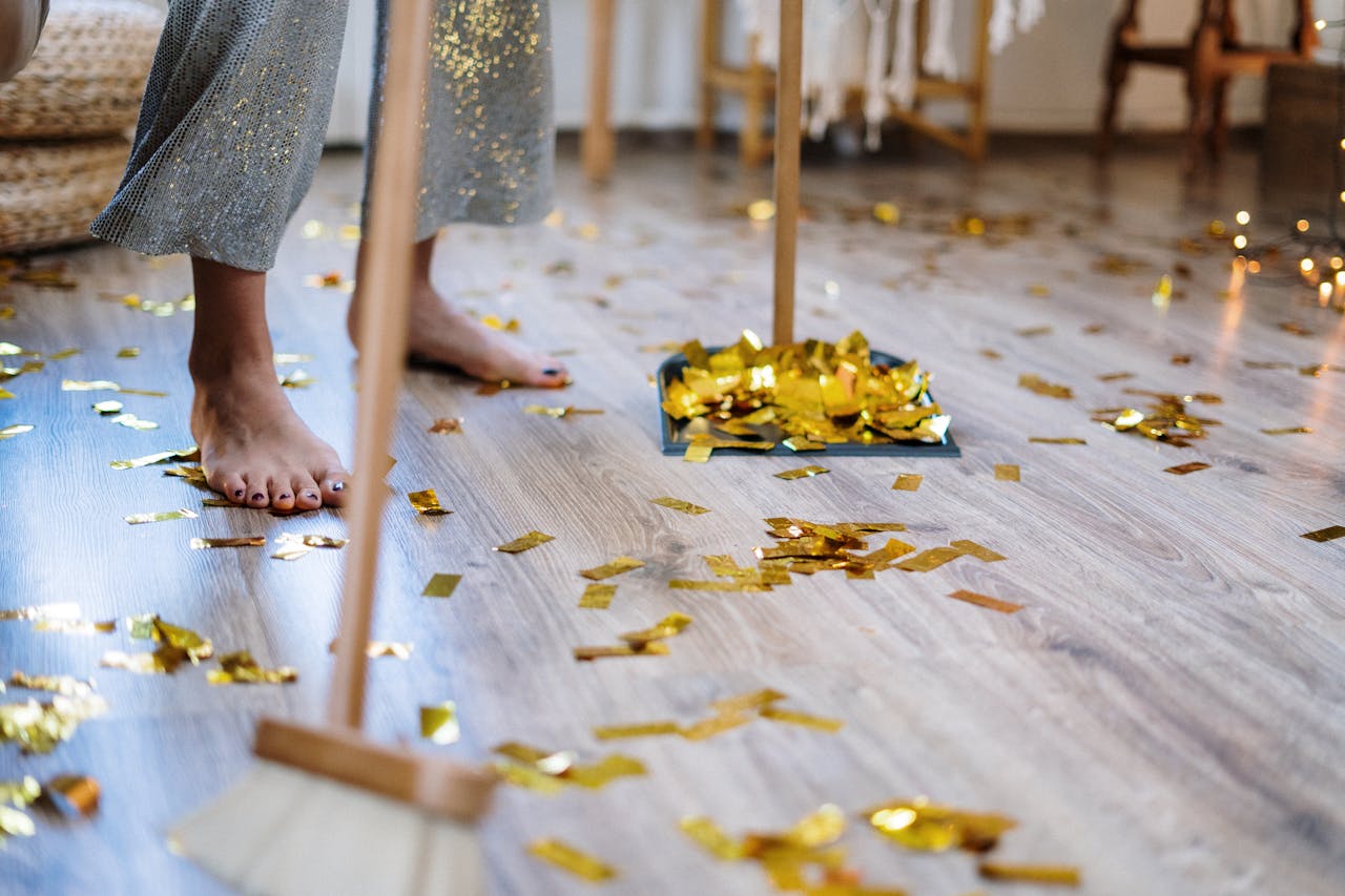 Person sweeping up confetti. Image by Pexels