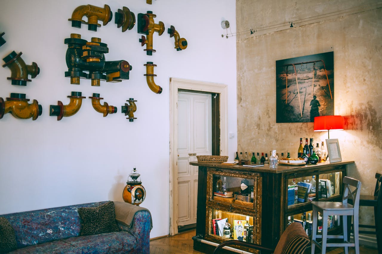 Interior of an apartment, pipes on wall as art. Image by Pexels