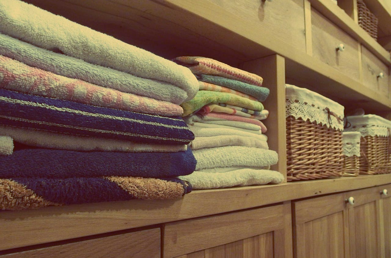 Stack of towels on a rack. Image by Pexels