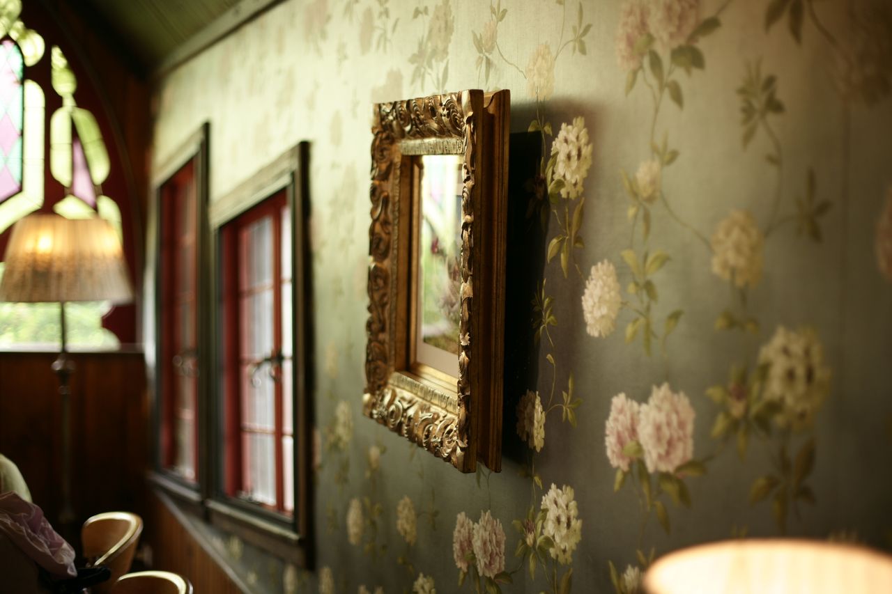 room with floral wallpaper. Image by Pexels