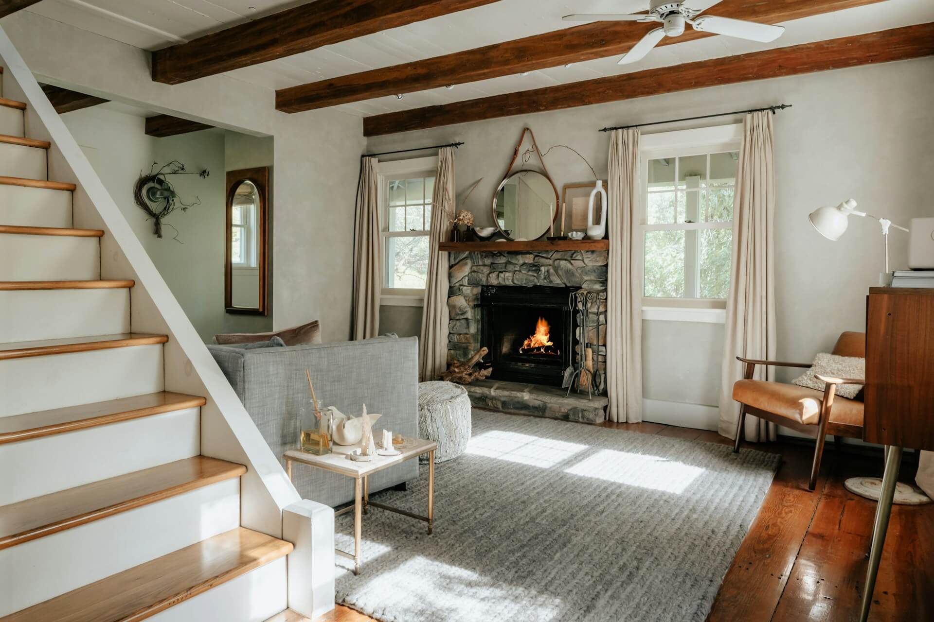 Livingroom with a  fireplace and furniture. Stairs. Image by Unsplash