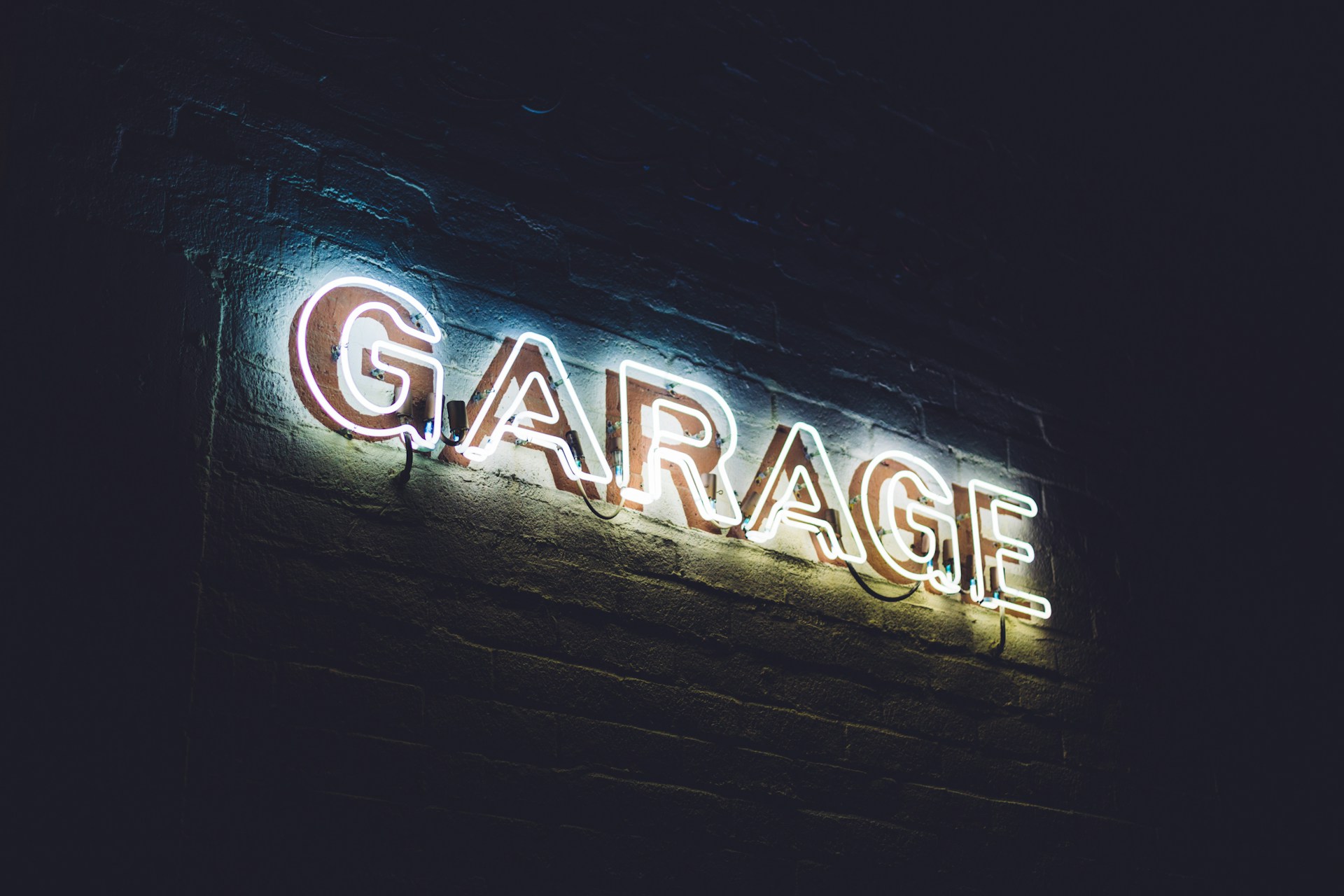 White neon garae light sign. Image by Patrick Fore on Unsplash.