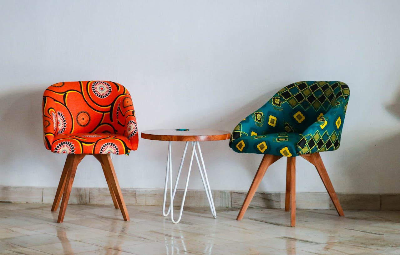 Two color chairs with various pattern near a table. Image by Pexel