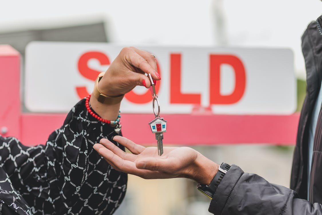 Sold sign, keys with a house keychain