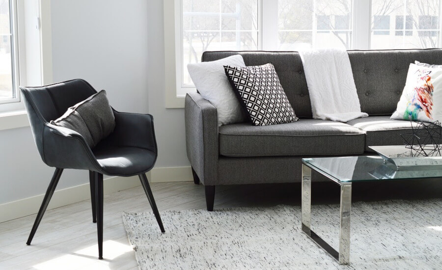 Grey sofa, chair and a table.