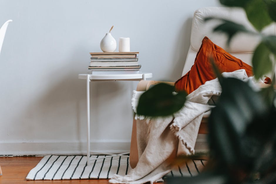 small table with striped rug under it, sofa