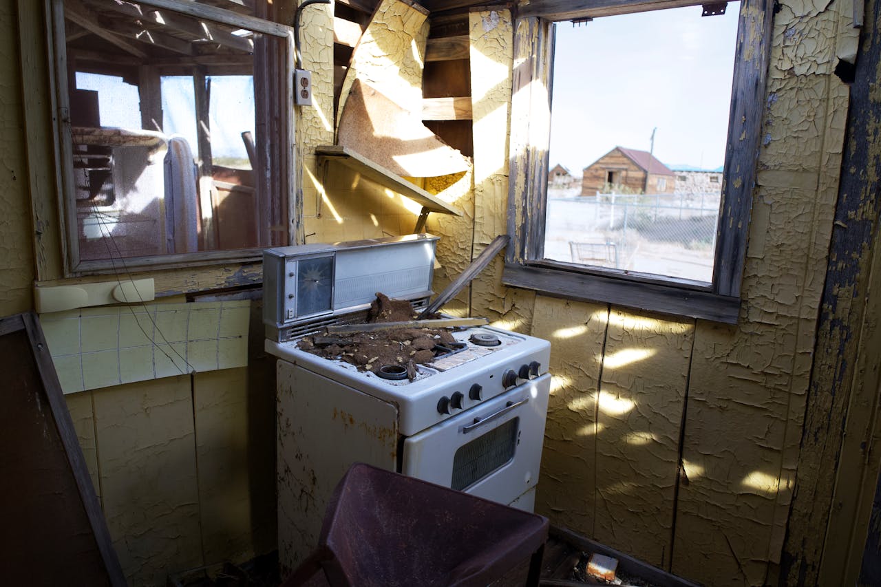 White stove, walls falling apart. Image by Pexels