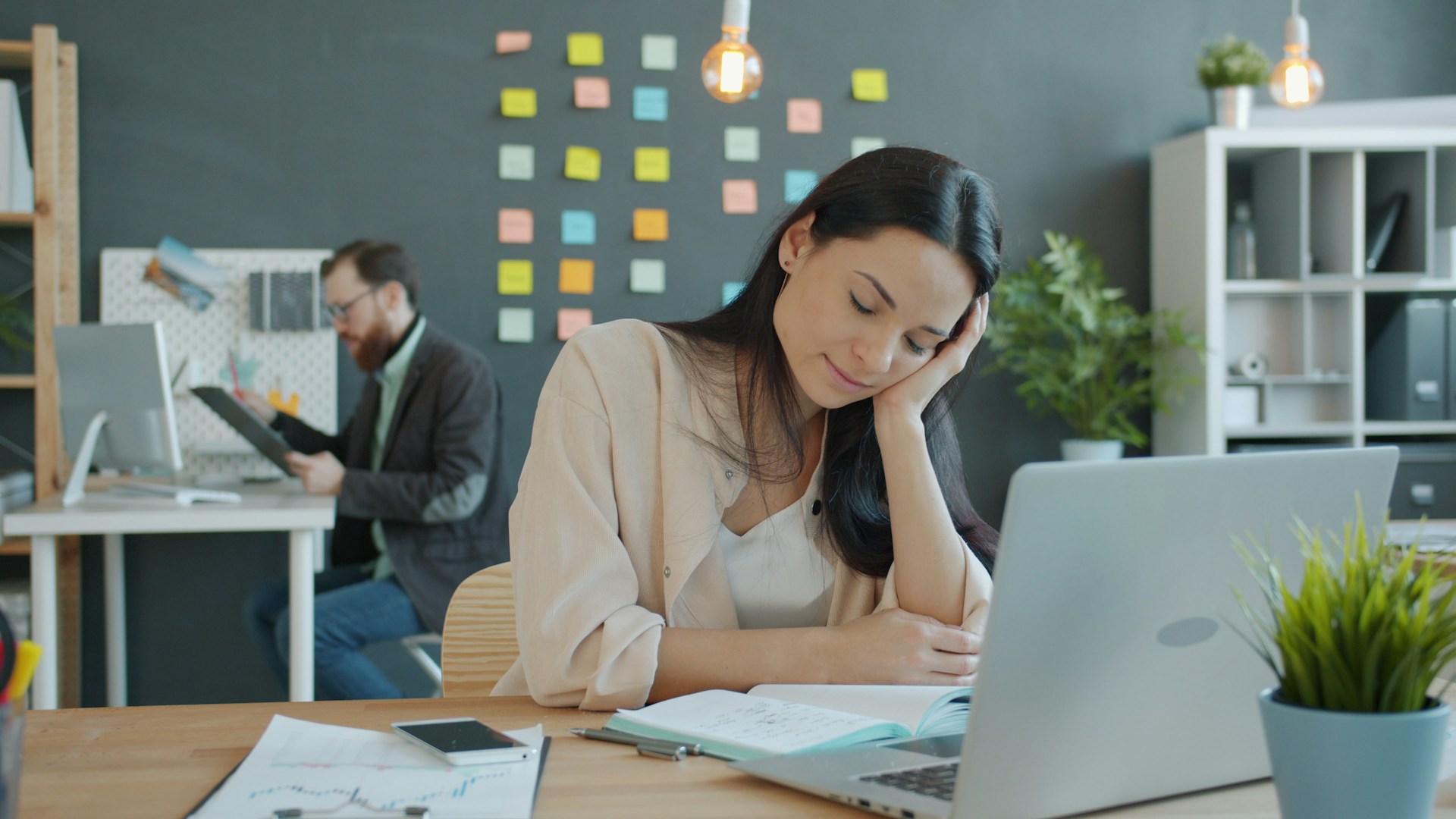 Tired startup founder asleep at a desk surrounded by laptops and notebooks representing chronic sleep deprivation among entrepreneurs. Image by Unsplash