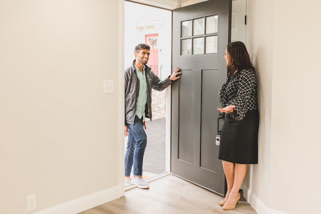 2 people standing in a doorway