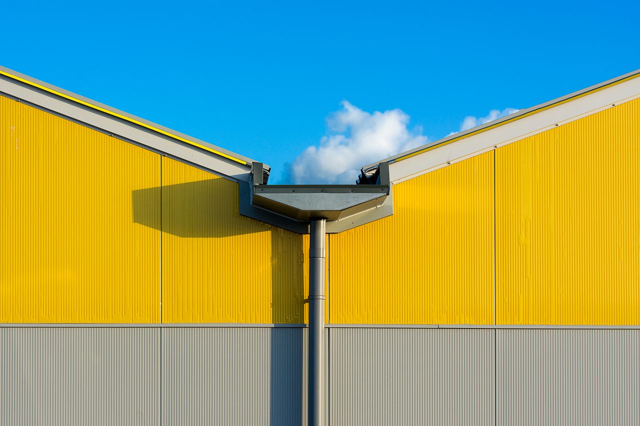 Yellow and gray exterior of a building. Image by Pexels